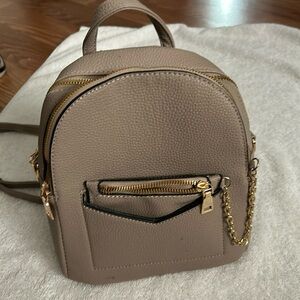 Leather backpack, mini a brown color with a gold chain for the long strap